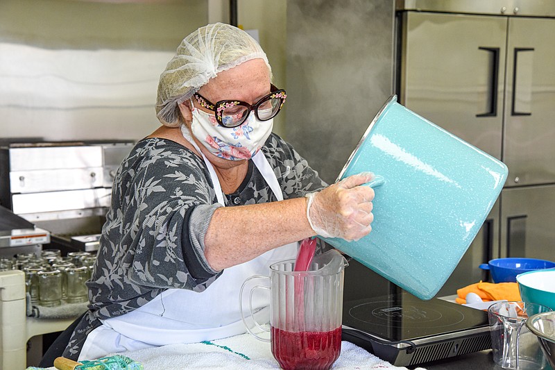 After boiling the mixture for several minutes, Theresa Prenger pours out the hot jelly. Prenger loves having the large amount of space that the commercial kitchen at Lincoln University Cooperative Culinary Incubator allows her to use.