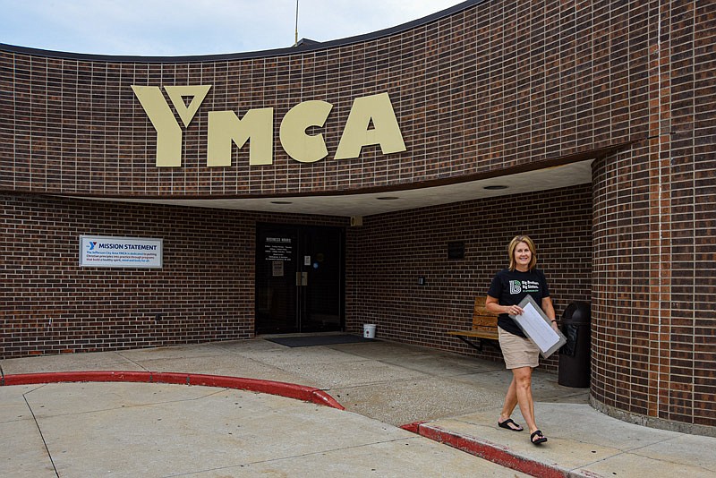Lee Knernschield exits Knowles YMCA Tuesday, Aug. 17, 2021, in Jefferson City after laminating signs for Friday's Big Brothers Big Sisters golf tournament at Hough Park Golf Course. YMCA officials sent a request for volunteers to the United Way office for the upcoming Days of Caring. Knernschield, who serves as executive director of BBBS, has office space in the Knowles annex next door. Both YMCA and BBBS are United Way partner agencies working to serve the community.