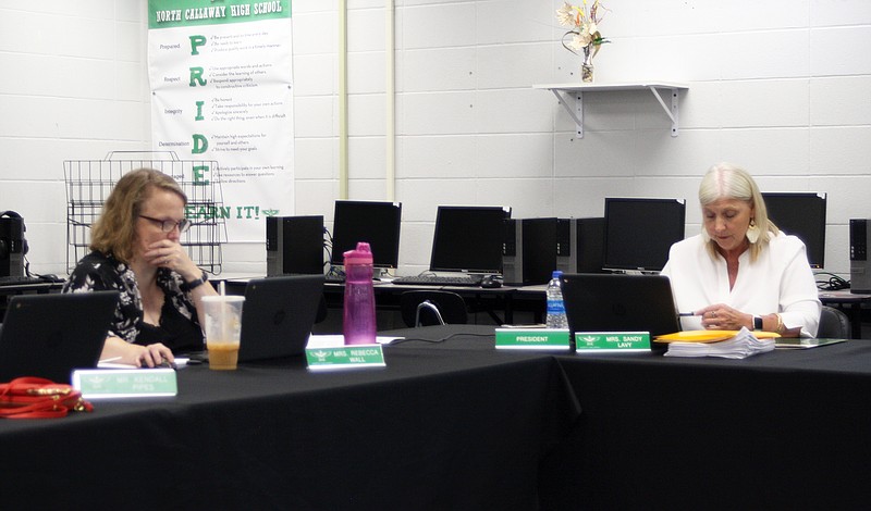 North Callaway school board member Rebecca Wall and board president Sandy Levy look through documents during Thursday's school board meeting.