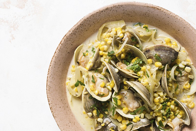 This image released by Milk Street shows a recipe for steamed clams with corn, fennel and crème fraîche. (Milk Street via AP)