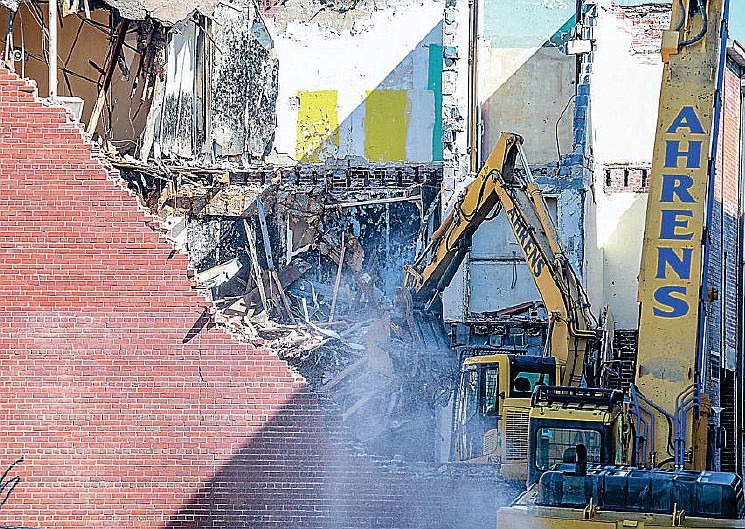 In order to minimize the amount of dust flying in the air, a constant spray of water is applied to the demolition site on Tuesday, Aug. 24, 2021, in the rear of 206-210 E. High St., the former JC Penney building in downtown Jefferson City. The rear portion of the building is being removed due to damage caused by water infiltration over time. ARSI is the job's contractor on which the demolition work was subcontracted to Ahrens Demolition of St. Louis.