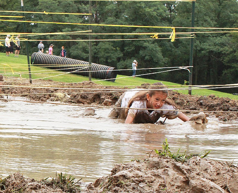 News Tribune fileJilian Moseley, 9, goes through the mud crawl, one of the many obstacles during the 2019 Catch Me If You Can Fun Run and Obstacle Course.