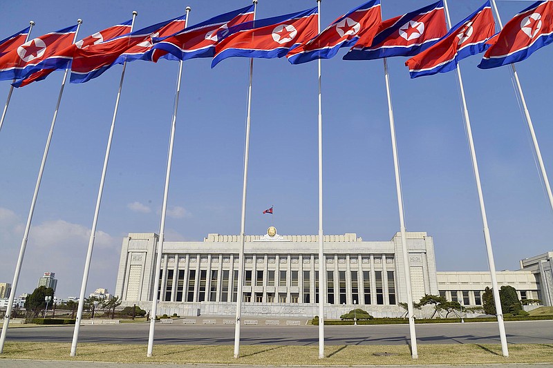 FILE - In this April 9, 2020, file photo, North Korean flags flutter in front of the Presidium of the Supreme People's Assembly building in Pyongyang, North Korea. North Korea will convene its rubber-stamp parliament on Sept. 28, 2021 to discuss efforts to salvage an economy strained by pandemic border closures after decades of mismanagement and U.S.-led sanctions. (Kyodo News via AP, File)