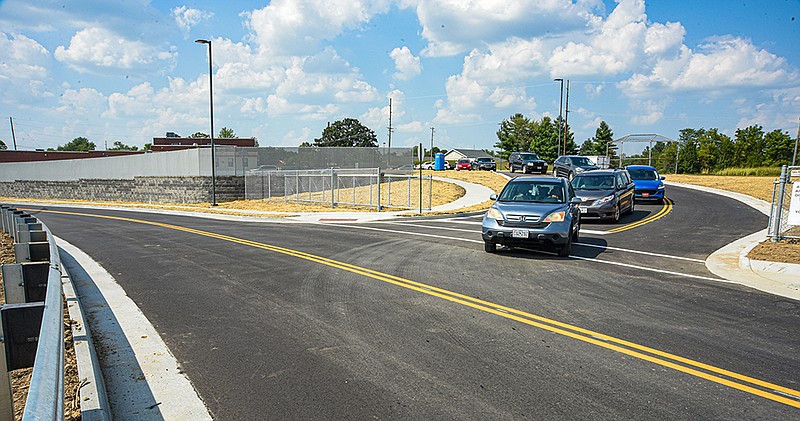 <p>Julie Smith/News Tribune</p><p>Parents exit from the new road, Patriot Drive, to West Edgewood Drive Friday after picking up their students at Lawson Elementary School. A roadway from West Edgewood to Thomas Jefferson Middle School, with an entrance to Lawson, was constructed over the summer in an effort to relieve the traffic congestion on Fairgrounds Road.</p>