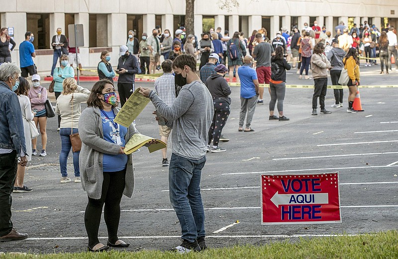 People wait in a long line on Oct. 13, 2020, to vote at an early voting location at the Renaissance Austin Hotel in Austin, Texas. (Jay Janner/Austin American-Statesman/TNS)