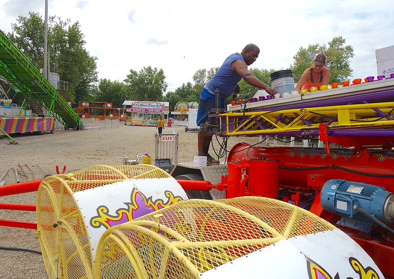 <p>Helen Wilbers/FULTON SUN Carnival workers prepare for the 2017 Mokane World’s Fair. The fair is back with a little bit of everything for its 71th year.</p>