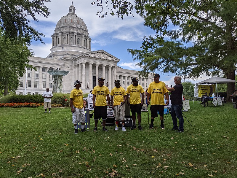 Representatives from the National Organization of Exonerees stand together at the rally. The organization sponsored the event, along with several others. Photo by Ryan Pivoney