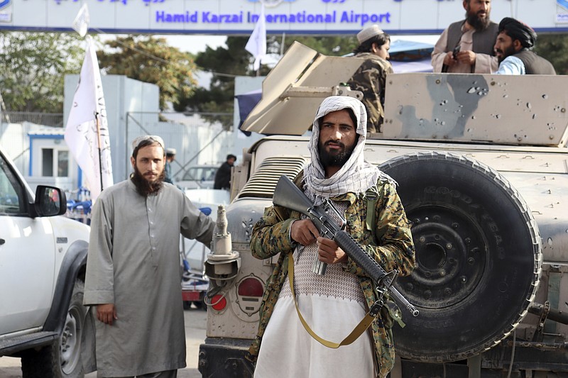 Taliban fighters stand guard in front of the Hamid Karzai International Airport after the U.S. withdrawal in Kabul, Afghanistan, Tuesday, Aug. 31, 2021. The Taliban were in full control of Kabul's international airport on Tuesday, after the last U.S. plane left its runway, marking the end of America's longest war. (AP Photo/Khwaja Tawfiq Sediqi)