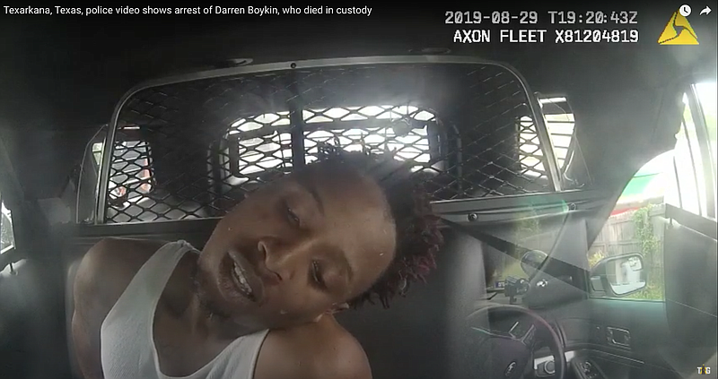This screen capture from a Texarkana Texas Police Department dashboard camera shows Darren Boykin in the back seat of a patrol vehicle after his arrest Aug. 29, 2019. Boykin later died while still in police custody. His mother has sued the department for wrongful death.