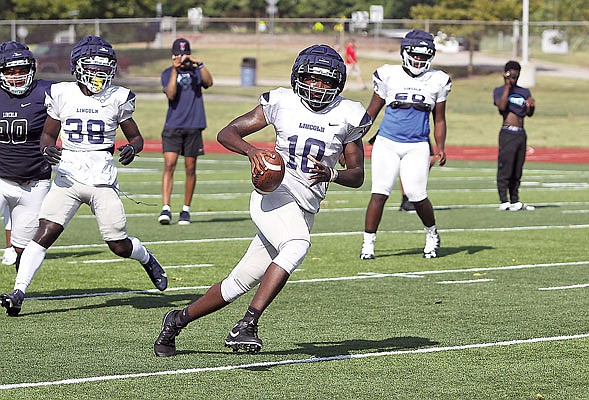 Lincoln quarterback Zamar Brake scrambles with the ball during last month's scrimmage at Dwight T. Reed Stadium.