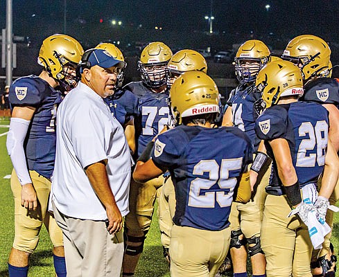 Helias coach Chris Hentges talks with his team during last Friday night's game against Hannibal at Ray Hentges Stadium.