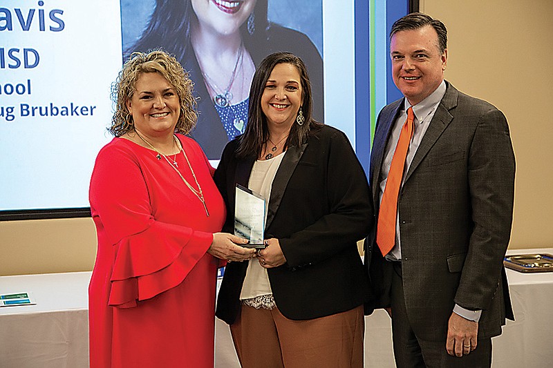 Stacy Elledge, from left, Debbie Davis and Dr. Doug Brubaker are shown as Davis is presented her award.