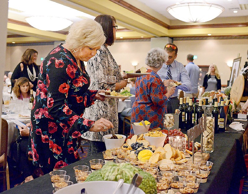 News Tribune file 
Beverly Stafford samples food pairings to go with her red wine from Les Bourgeois Vineyards during the 2019 Cork, Fork & Brews fundraiser at Capitol Plaza Hotel. The dinner auction gives tribute to local chefs, restaurants and caterers while raising money to support development programs with Boys & Girls Club for local at-risk youth.