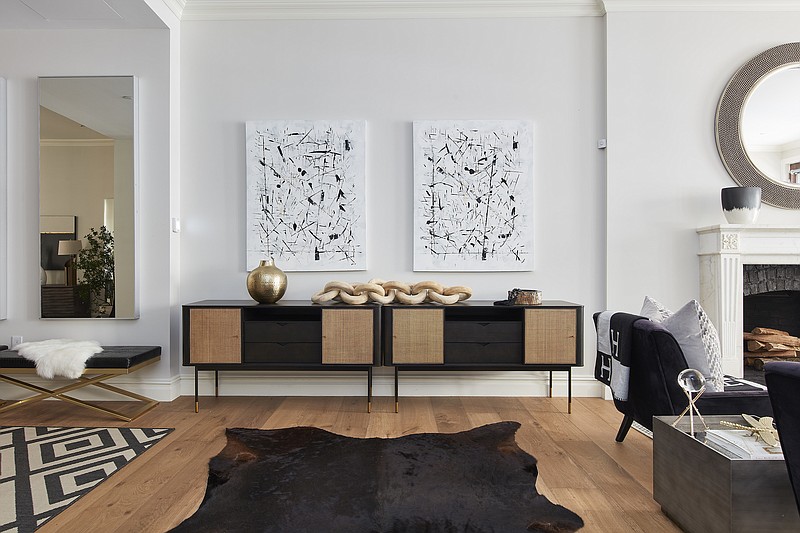 Various accents of black from benches,consoles, side chairs creates a wow factor in this living room. (Scott Gabriel Morris/TNS)