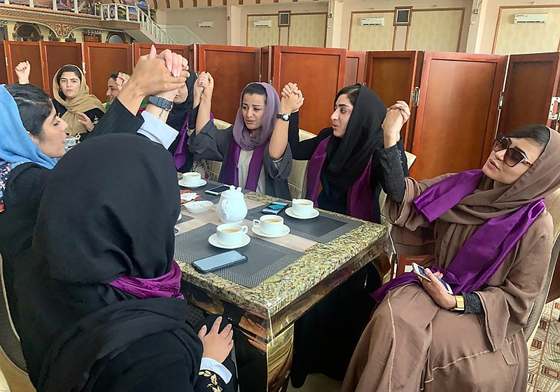 Women gather to demand their rights under the Taliban rule during a protest in Kabul, Afghanistan, Saturday, Sept. 4, 2021. The Taliban have promised an inclusive government and a more moderate form of Islamic rule than when they last ruled the country from 1996 to 2001. But many Afghans, especially women, are deeply skeptical and fear a rollback of rights gained over the last two decades. (AP Photo/Kathy Gannon)