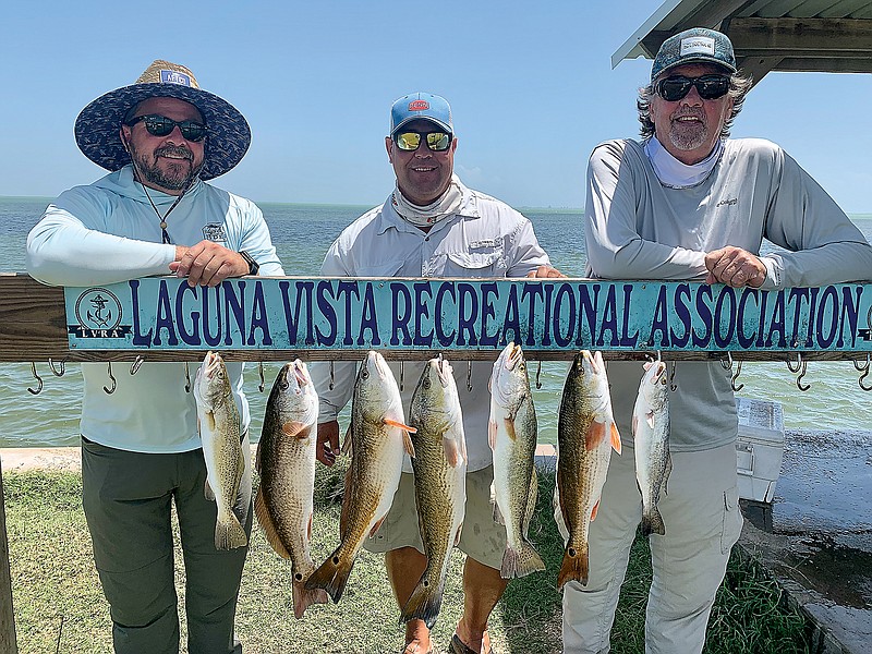 Brandon Butler, captain Mike Mahl and Steve Brigman pose with a few fish for the freezer from Laguna Madre.
