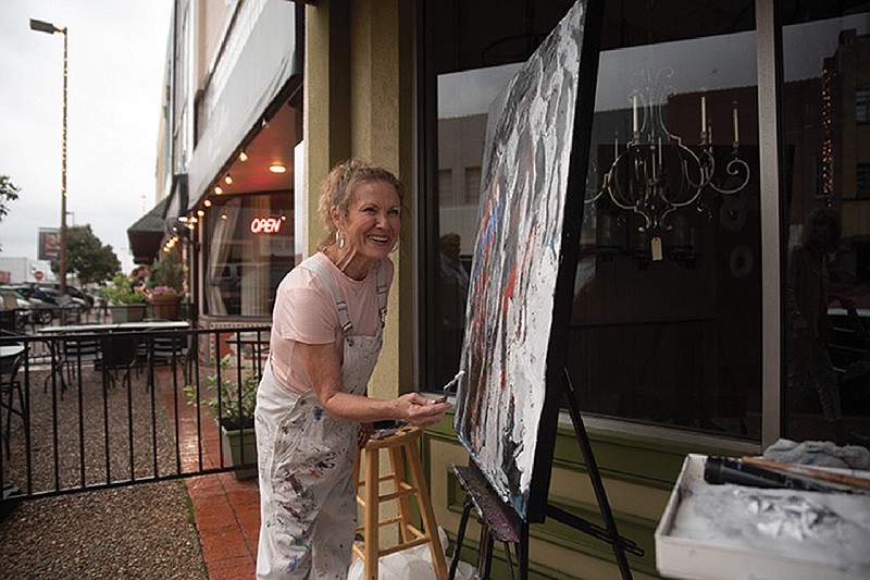 Local artist Judy Jones paints a piece during the Downtown Live event in May.