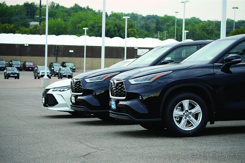  A pair of unsold 2021 Highlander sports utility vehicles and a Camry sedan are parked on the empty storage lot outside a Toyota dealership in Englewood, Colo.