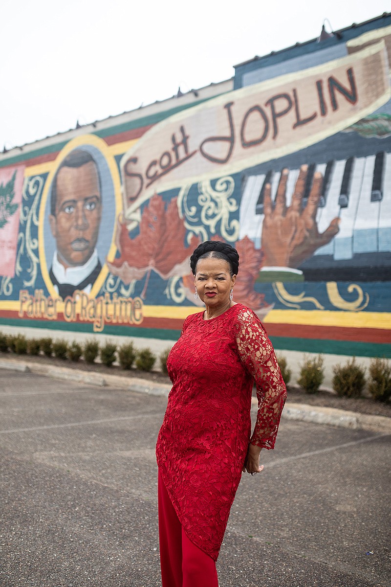 Carol Collins-Miles poses in front on the Scott Joplin mural in downtown Texarkana earlier this year. Carol says promoting Texarkana and music from Texarkana is important to her.