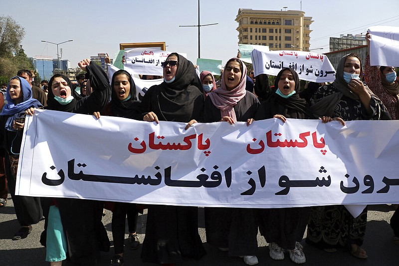 Afghans shout slogans during an anti-Pakistan demonstration, near the Pakistan embassy in Kabul, Afghanistan, Tuesday, Sept. 7, 2021. Sign in Persian reads, "Pakistan Pakistan Get out of Afghanistan." (AP Photo/Wali Sabawoon)