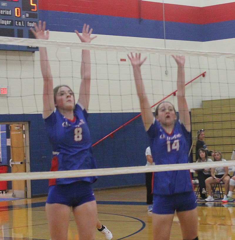 <p>Democrat photo/Evan Holmes</p><p>Emma Whitson (left) and Lauren Friedrich (right) rise for a tandem block in their opening set against Boonville.</p>