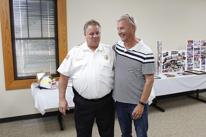<p>Democrat photo/
Austin Hornbostel</p><p style="text-align:right;">Retiring California Fire Chief Allen Smith and long-time California mayor Norris Gerhart embrace at Smith’s retirement reception last Thursday. Earlier that afternoon, Gerhart presented Smith with a plaque on behalf of the city of California in appreciation of his 37 years of service.</p>