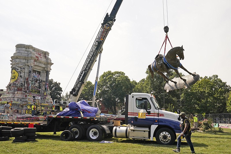 Crews move the horse of Confederate General Robert E. Lee one of the country's largest remaining monuments to the Confederacy, on Monument Avenue in Richmond, Va., Wednesday, Sept. 8, 2021. (AP Photo/Steve Helber)