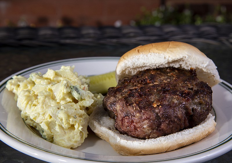 A cheeseburger with a side of potato salad, on Wednesday, August 11, 2021. (Colter Peterson/St. Louis Post-Dispatch/TNS)