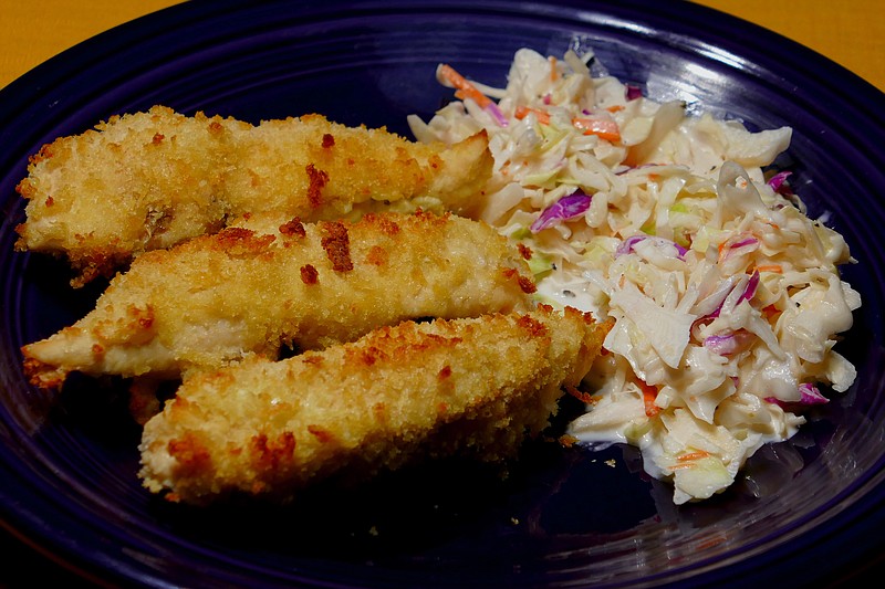 Oven-fried chicken tenders with coleslaw. (Linda Gassenheimer/TNS)