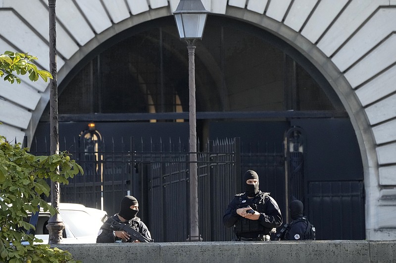 Security forces guard an entrance of the Palace of Justice Wednesday, Sept. 8, 2021 in Paris. France is putting on trial 20 men accused in the Islamic State group's 2015 attacks on Paris that left 130 people dead and hundreds injured. The proceedings begin Wednesday in an enormous custom-designed chamber. Most of the defendants face the maximum sentence of life in prison if convicted of complicity in the attacks. Only Abdeslam is charged with murder. (AP Photo/Francois Mori)