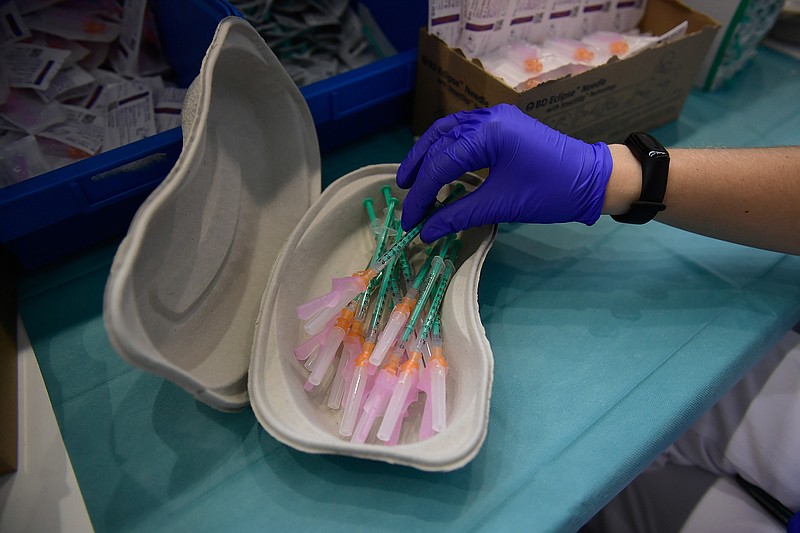 In this Thursday, Sept. 2, 2021 file photo, a health worker prepares Pfizer vaccines during the national COVID-19 vaccination campaign in Pamplona, northern Spain. In a statement Monday Sept. 6, 2021, the European Medicines Agency says it has started an expedited evaluation on whether to recommend a booster dose of the coronavirus vaccine made by Pfizer-BioNTech. (AP Photo/Alvaro Barrientos, File)