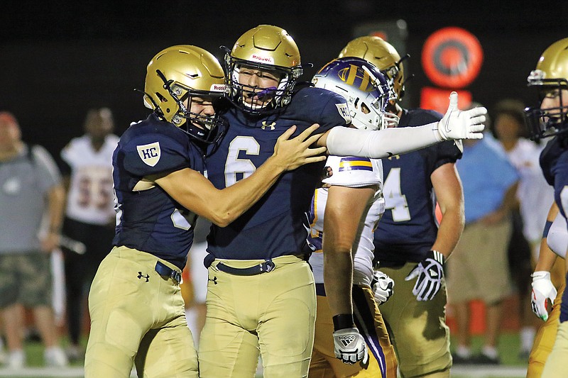 Helias defensive back Sam Hentges hugs defensive back Carson Brauner after Brauner intercepted a pass during the Sept. 3, 2021, game against Hickman at Ray Hentges Stadium. 