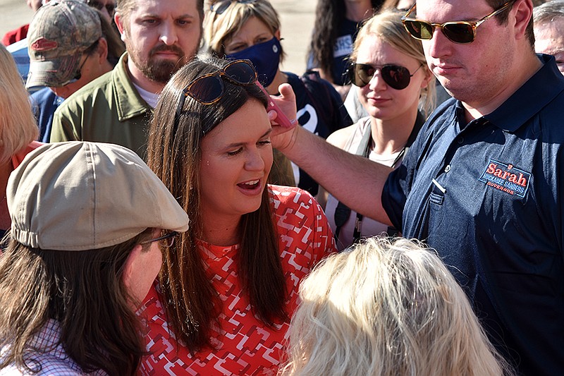 Arkansas gubernatorial candidate Sarah Huckabee Sanders speaks with people gathered at a campaign stop Friday, Sept. 10, 2021, in Texarkana, Arkansas.