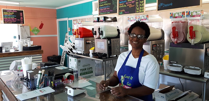 Shandralyn Smith, owner of Get It -N-Go, greets customers at her frozen drink outlet.