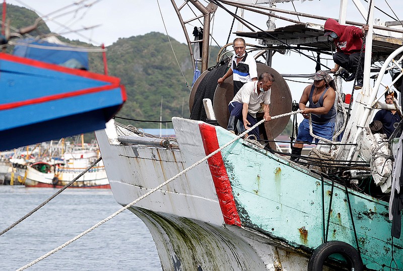 Fishermen fasten the boat as Typhoon Chanthu approaches to Taiwan in Keelung, New Taipei City, Taiwan, Saturday, Sept. 11, 2021. Taiwan's weather bureau warned of high winds and heavy rain as Typhoon Chanthu roared toward the island Saturday and said the storm's center was likely to pass its east coast instead of hitting land. (AP Photo/Chiang Ying-ying)
