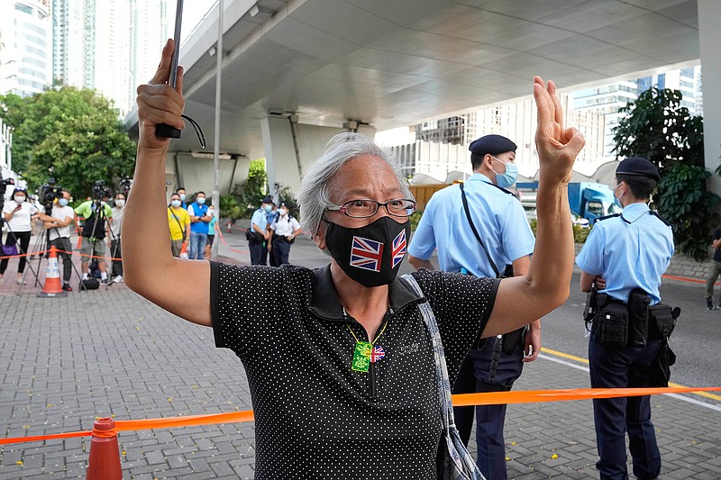 A supporter of the Hong Kong Alliance in Support of Patriotic Democratic Movements of China protests outside a court, in Hong Kong, Friday, Sept. 10, 2021. Hong Kong police charged the group that organizes the city's annual Tiananmen candlelight vigil and three of its leaders with subversion under the national security law, amid an ongoing crackdown on dissent. (AP Photo/Kin Cheung)