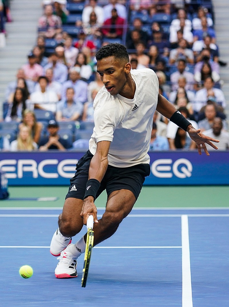 Felix Auger-Aliassime, of Canada, returns a shot to Daniil Medvedev, of Russia, during the semifinals of the US Open tennis championships, Friday, Sept. 10, 2021, in New York. (AP Photo/Seth Wenig)