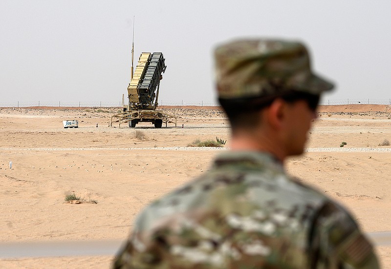 In this Feb. 20, 2020, file pool photo, a member of the U.S. Air Force stands near a Patriot missile battery at Prince Sultan Air Base in Saudi Arabia. The U.S. has removed its most advanced missile defense system and Patriot batteries from Saudi Arabia's Prince Sultan Air Base in recent weeks, even as the kingdom faced continued air attacks from Yemen's Houthi rebels, satellite photos analyzed by The Associated Press show. (Andrew Caballero-Reynolds/Pool via AP, File)