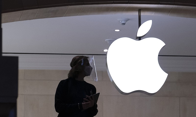 <p>AP</p><p>An Apple store employee is shown in a Feb. 5 photo in New York. Apple on Sept. 1 relaxed rules to allow some app developers such as Spotify, Netflix and digital publishers to include an outside link so users can sign up for paid subscription accounts.</p>