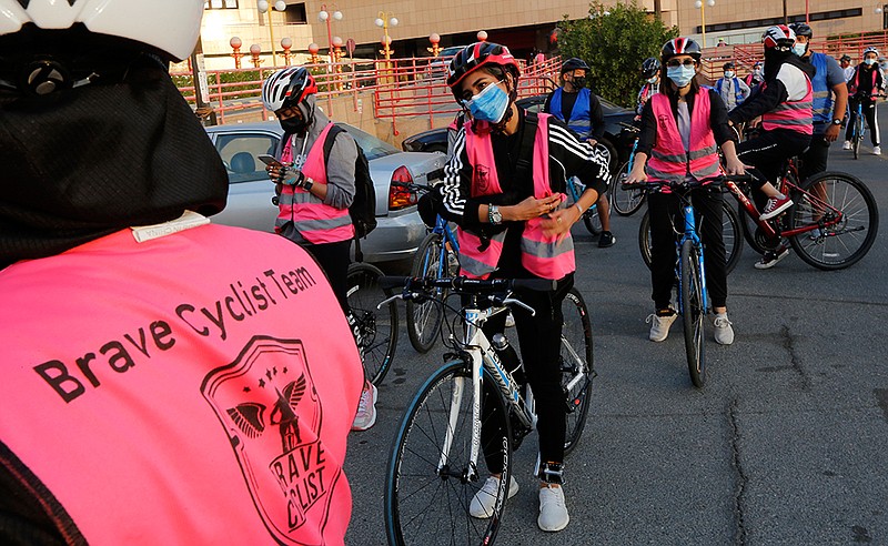 <p>Members of the women’s Brave Cyclist team prepare to start a tour March 6 in Jiddah, Saudi Arabia. The Brave Cyclist team, which was formed in 2019 aiming to normalize the sport for women, organized a tour cycling ahead of International Women’s Day. (AP Photo/Amr Nabil)</p>