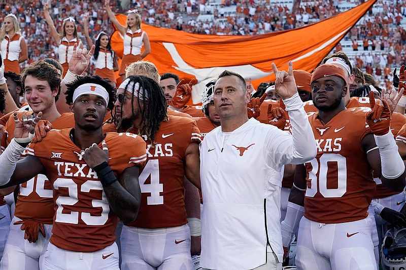 In this Saturday, Sept. 4, 2021, file photo, Texas head coach Steve Sarkisian, center, joins players in singing "The Eyes of Texas" after an NCAA college football against Louisiana-Lafayette, in Austin, Texas. The Texas chapter of the NAACP and a group of UT students have filed a federal civil rights complaint against the University of Texas for its continued use of "The Eyes of Texas" school song, tune with racist elements in its past. The complaint filed Friday, Sept. 3, 2021, with the U.S. Department of Education alleges that Black students and faculty are being subjected to violations of the Civil Rights Act and a hostile campus environment. (AP Photo/Eric Gay)