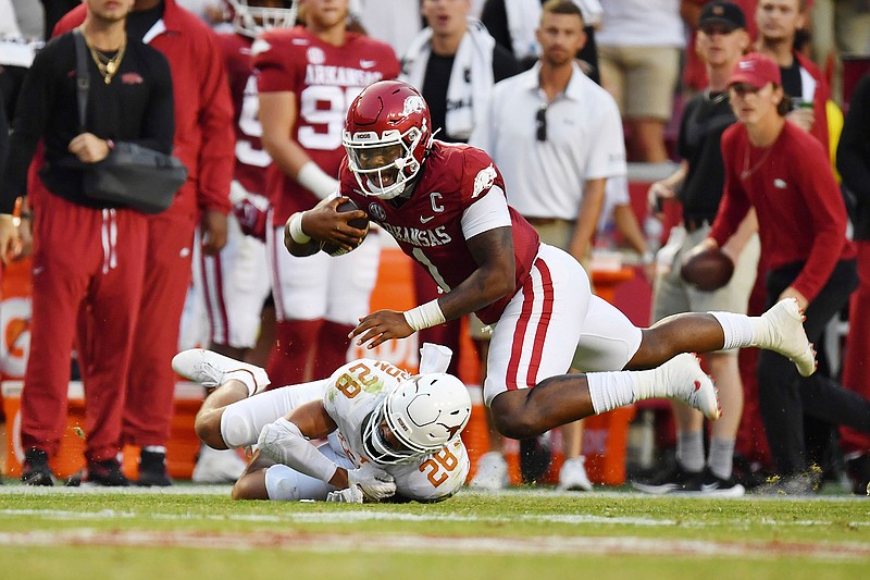 Arkansas quarterback KJ Jefferson (1) is tripped by Texas defender Jerrin Thompson (28) after a long gain during the first half of an NCAA college football game Saturday, Sept. 11, 2021, in Fayetteville, Ark. (AP Photo/Michael Woods)