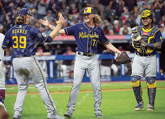 Brewers starting pitcher Corbin Burnes greets relief pitcher Josh Hader as catcher Omar Narvaez watches at the end of Saturday's combined no-hitter against the Indians in Cleveland.