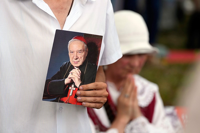 Catholic faithful attend the beatification ceremony of Polish Cardinal Stefan Wyszynski and Mother Elzbieta Roza Czacka in front of the church of Providence in Warsaw, Poland, Sunday, Sept. 12, 2021. Poland's top political leaders gathered in a Warsaw church Sunday for the beatification of two revered figures of the Catholic church — a cardinal who led the Polish church's resistance to communism and a blind nun who devoted her life to helping others who couldn't see. (AP Photo/Czarek Sokolowski)