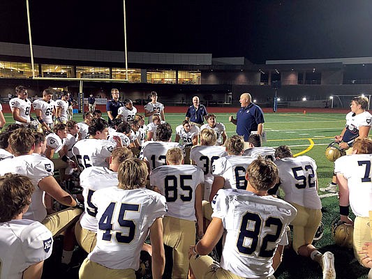 Helias coach Chris Hentges talks to the Crusaders after Friday night's 35-22 win against the Battle Spartans in Columbia.