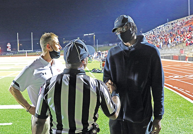Former Jefferson City Jays basketball player OG Anunoby speaks with a referee at halftime of Friday night's football game between Jefferson City and Rock Bridge at Adkins Stadium. Anunoby, who plays for the Toronto Raptors, had his No. 5 jersey retired Friday during a ceremony at midfield.