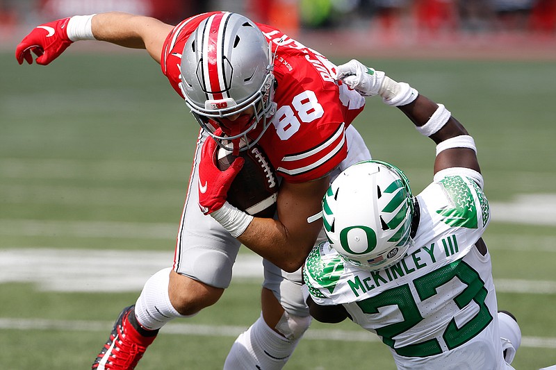 Oregon defensive back Verone McKinley, right, tackles Ohio State tight end Jeremy Ruckert during the second half of an NCAA college football game Saturday, Sept. 11, 2021, in Columbus, Ohio. Oregon beat Ohio State 35-28. (AP Photo/Jay LaPrete)