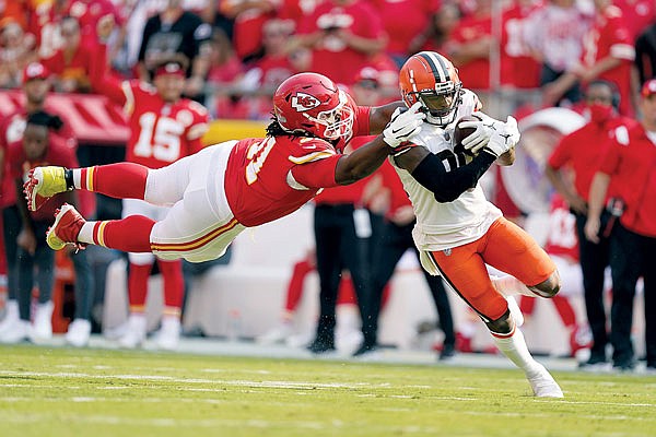 Browns wide receiver Jarvis Landry runs with the ball as Chiefs defensive tackle Derrick Nnadi leaps in an attempt to bring him down during Sunday afternoon's game at Arrowhead Stadium.