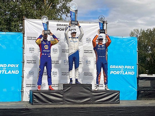Alex Palou (center) celebrates his third IndyCar win of the season Sunday at Portland International Raceway in Portland, Ore.