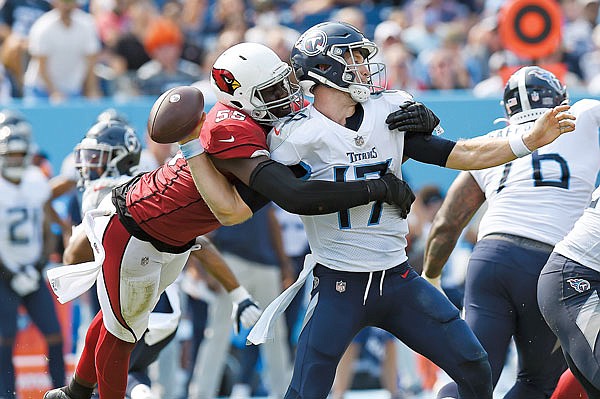 Cardinals linebacker Chandler Jones sacks Titans quarterback Ryan Tannehill and forces a fumble the Cardinals recovered in Sunday's game in Nashville, Tenn.